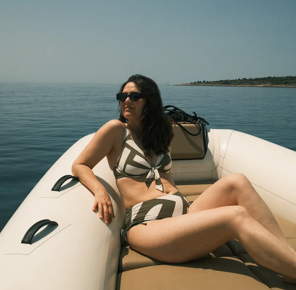 woman in retro style bikini relaxing on boat