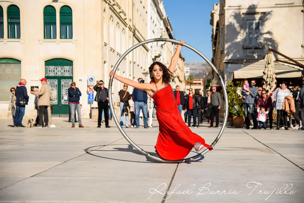 maria-lopez-cyr-wheel-red-dress-street-performance-split