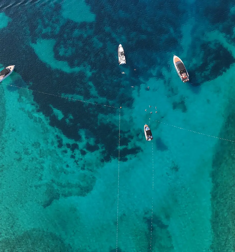 drone overhead of four boats anchored